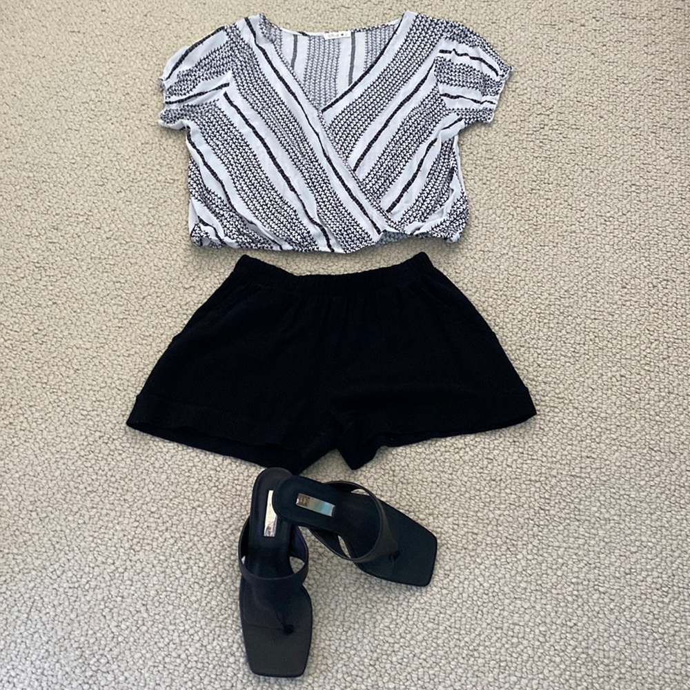 Beautiful black/white top faux wrap over, elasticated bottom.  Size small.